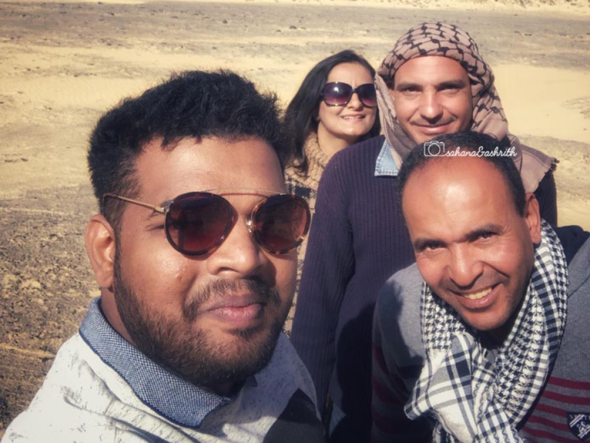 Egyptian guide with Indian travellers at black desert