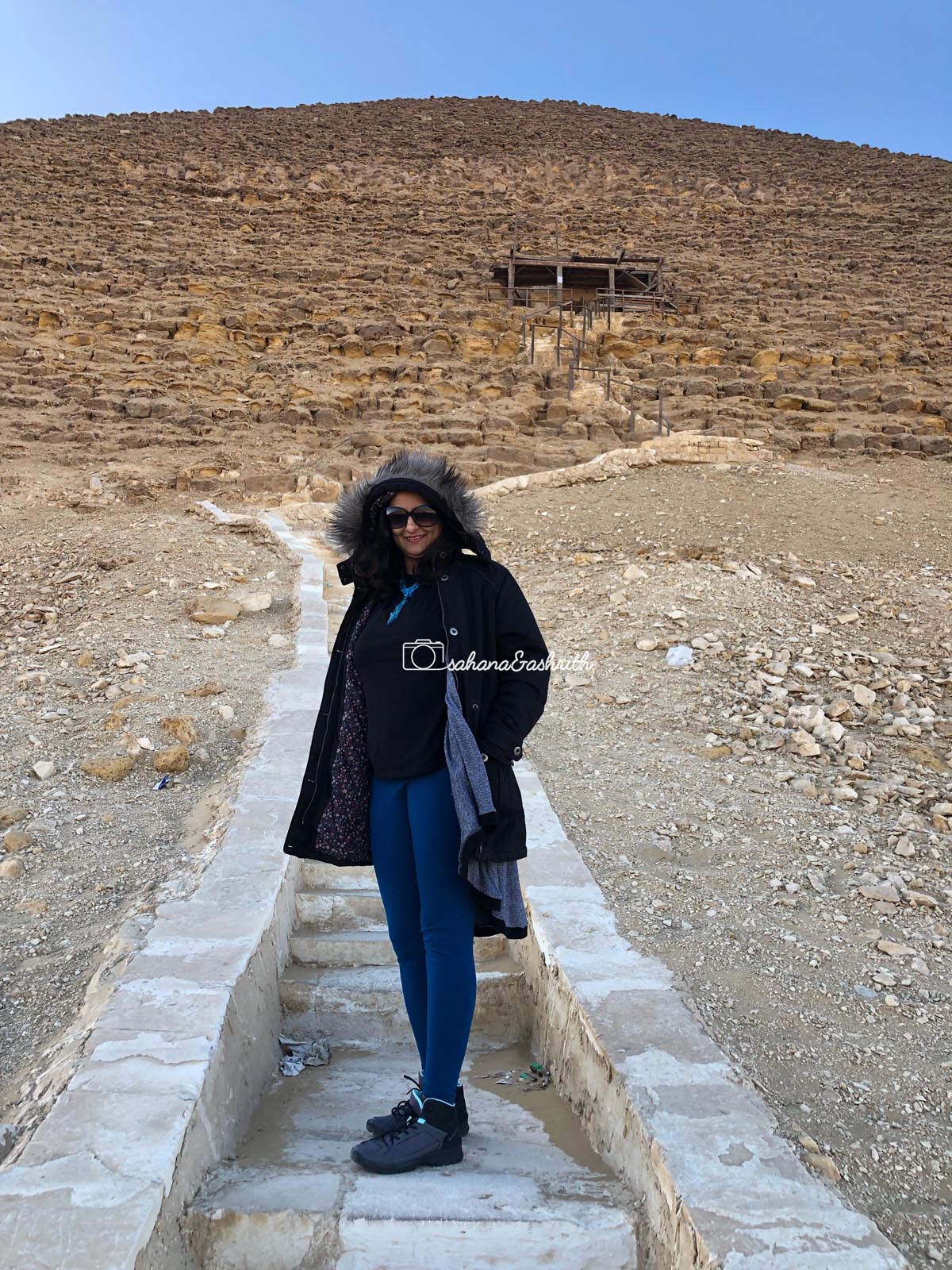 Indian woman traveller standing in front of Red Pyramid entrance
