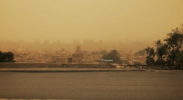 Travelling in Egypt;s sandstorm with city almost covered in sand making it blur