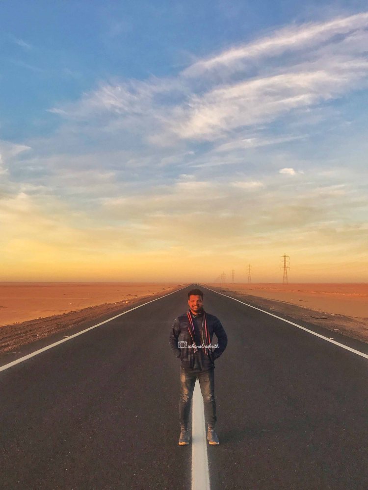 Straight road in the desert during twilight