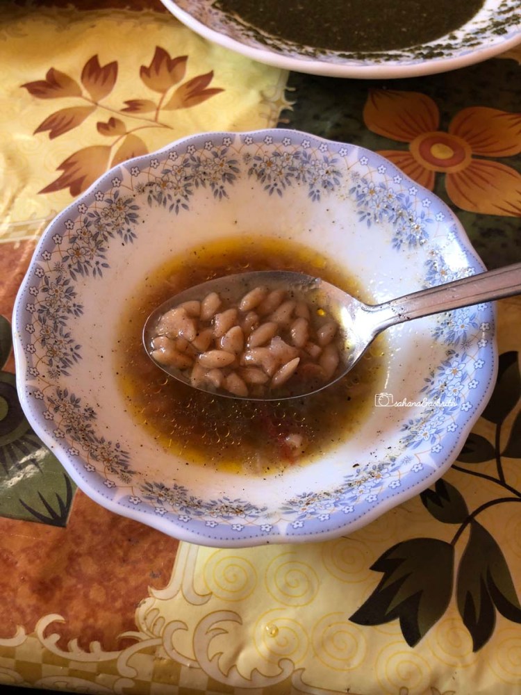 vegetarian food in Egypt - White bowl of soup with white fawa beans floating