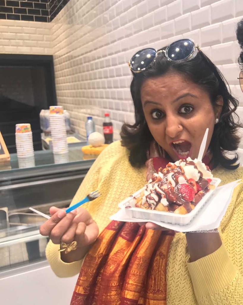An Indian woman traveller eating waffles in Belgium's Brussels