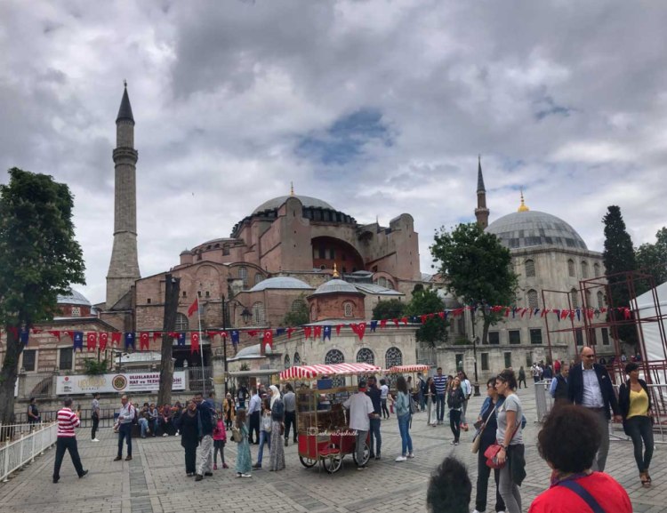 Travellers and simit cart in front of hagia sophia