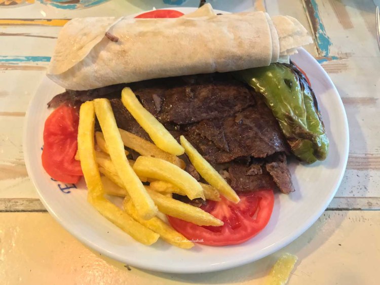 Kabab wrap on plate with fries and veggies at Istanbul