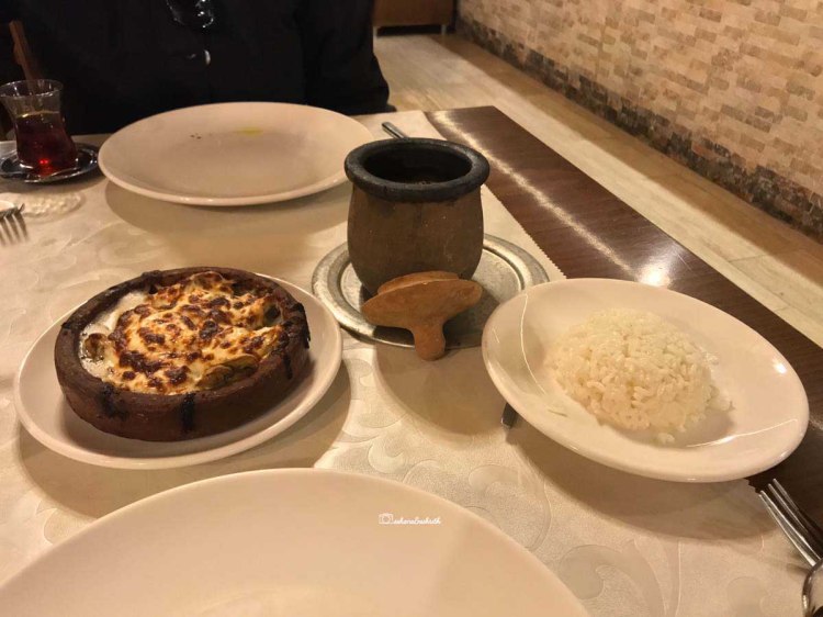 Clay pot of beans curry , plate of rice and baked chese with mushroom in Cappadocia