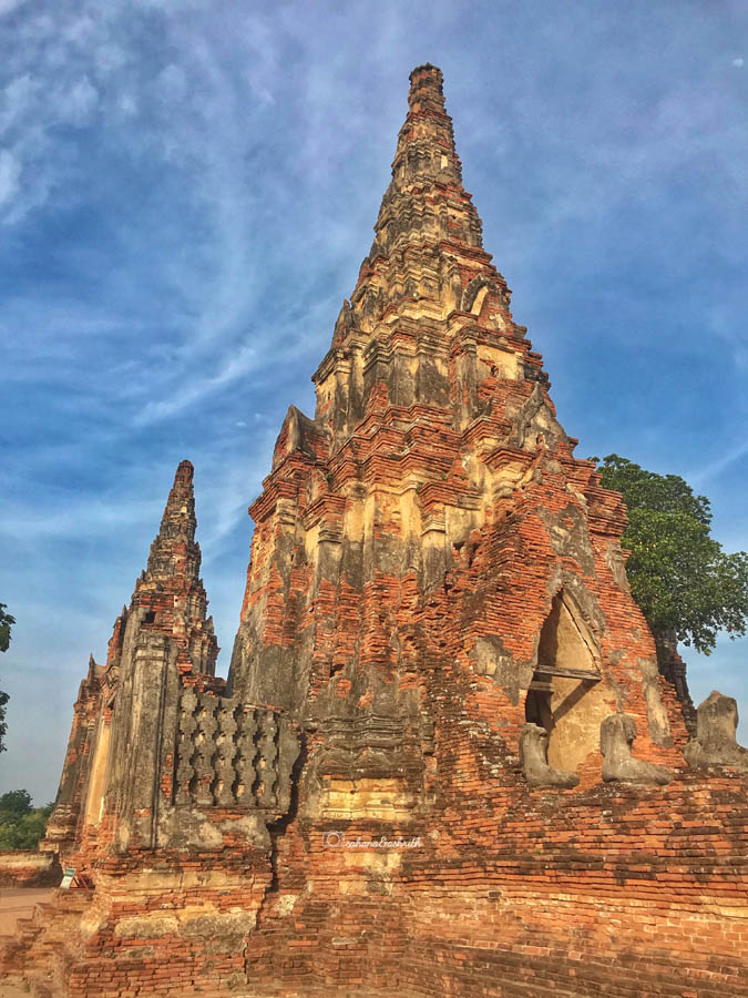 tall brick chedi with carvings in ayutthaya ruin