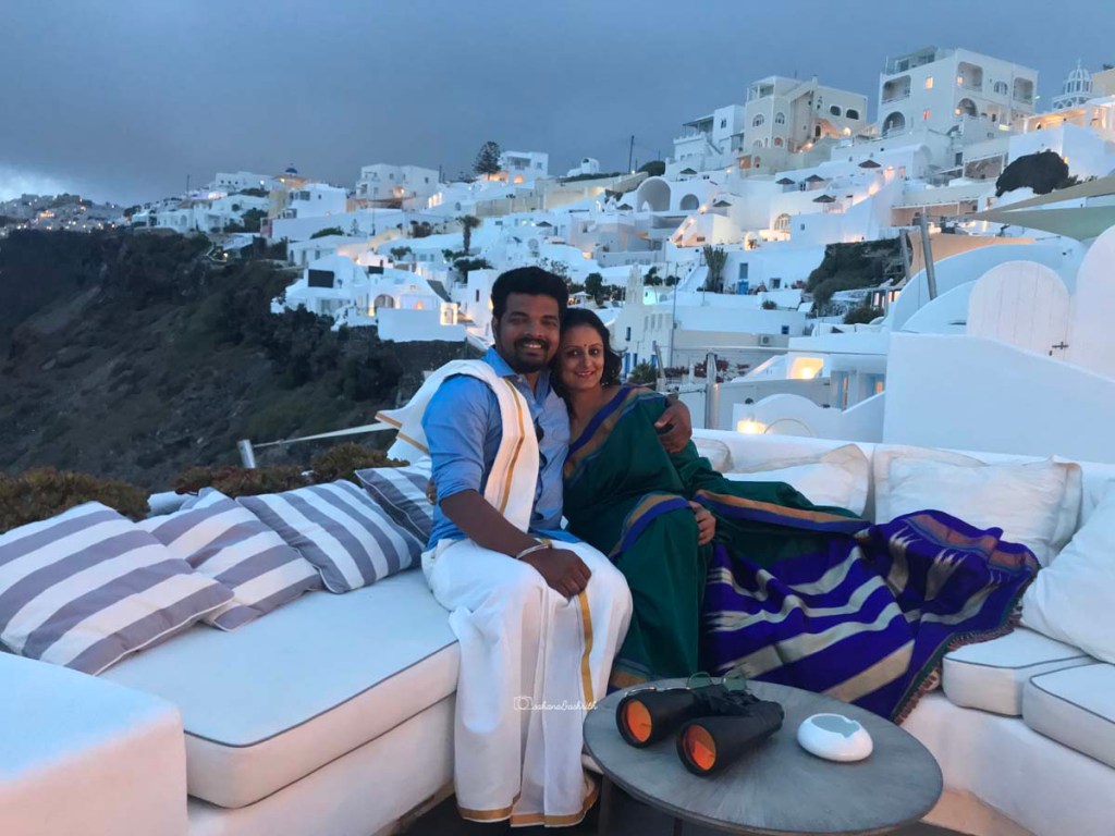 Indian man in dhoti and shirt along with Indian woman in Ilkal saree at Santorini