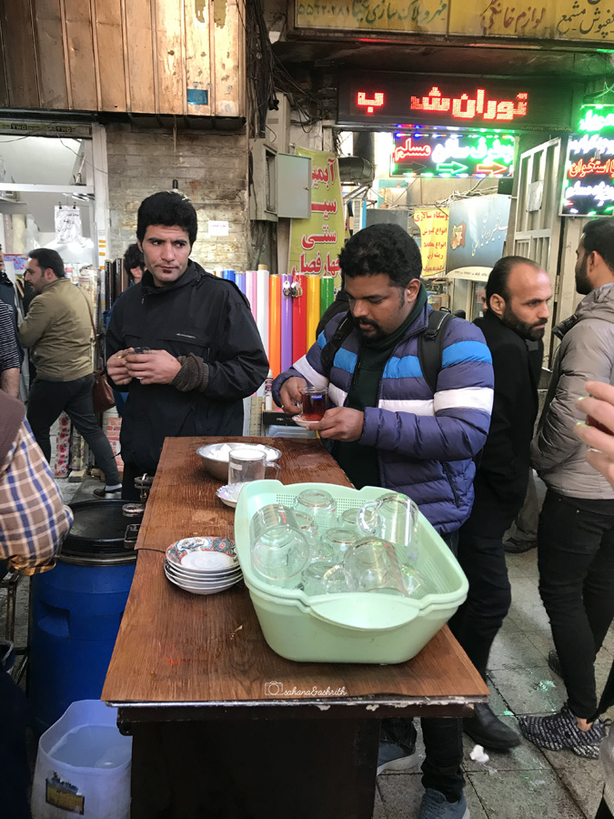 Indian man drinking tea and Iranian man staring at him for taking just one cube of sugar