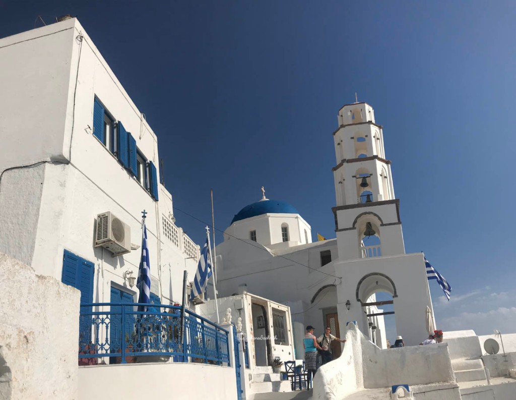 Blue window and blue metal raining for a white building along with Greece flag in Pyrgos