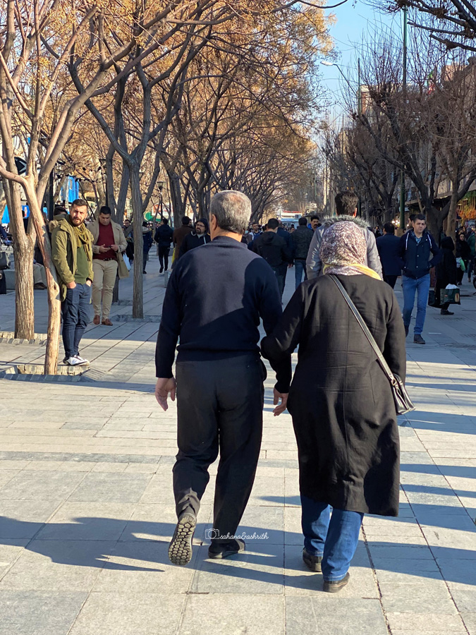 Old Iranian couple wallking holding hands in Tehran