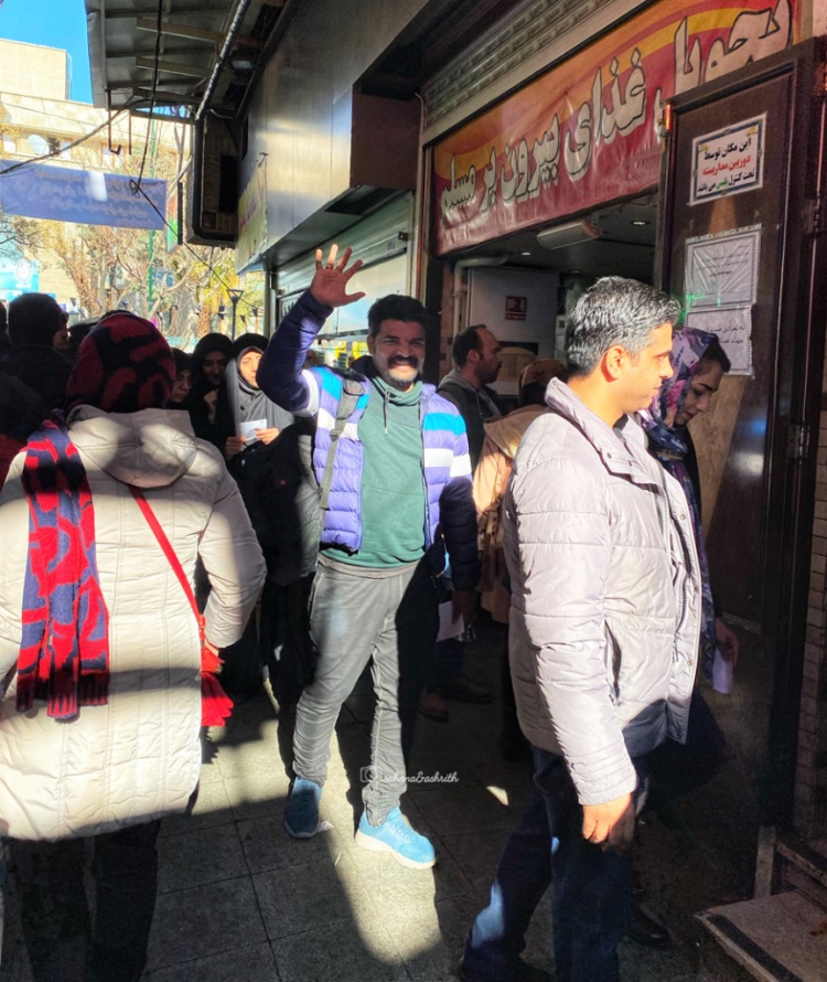 Indian traveller standing in the line to get inside a famous restaurant at Tehran