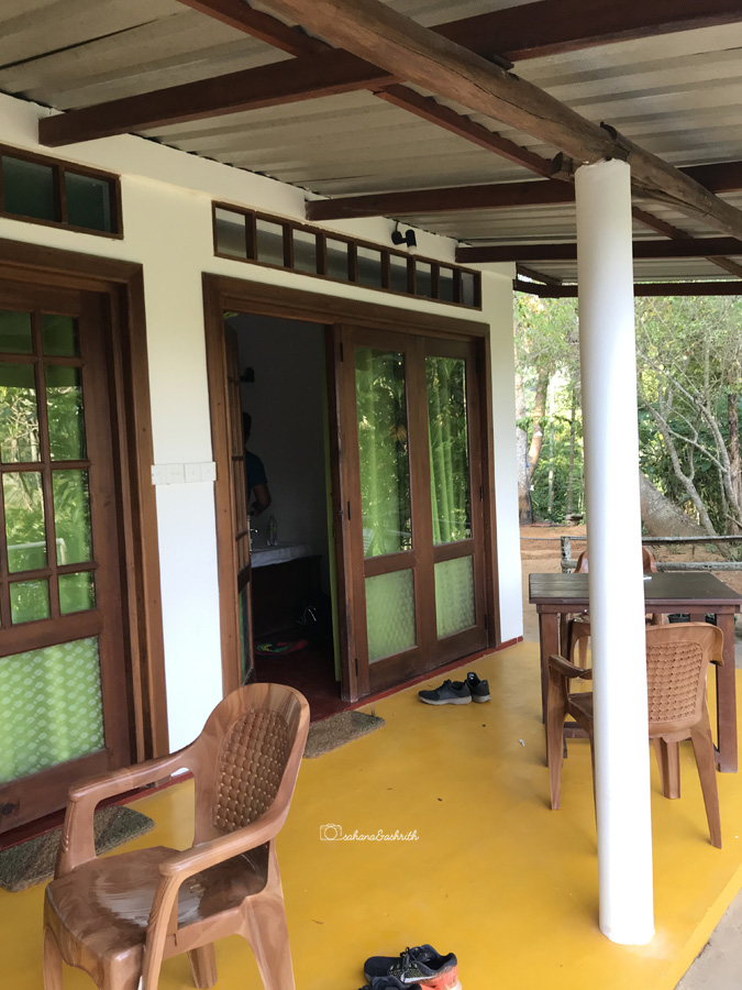 Small homestay with yellow colour floor, white walls and green glass windows at Ella, Sri Lanka