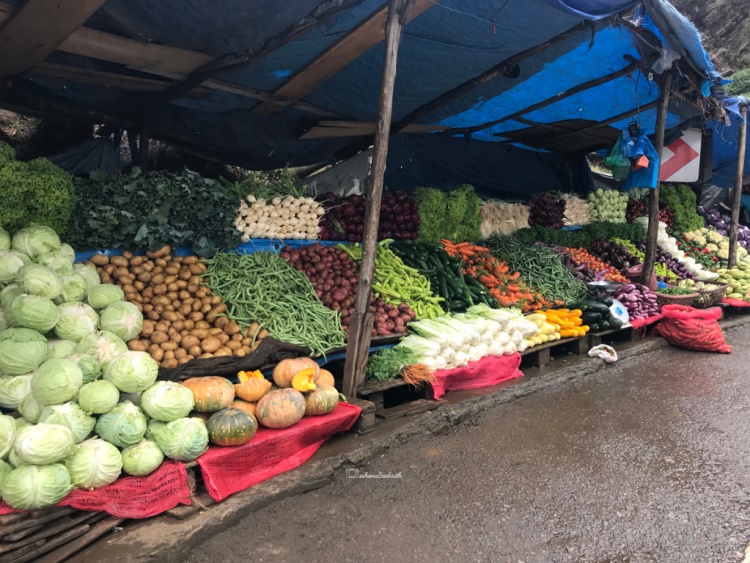 Vegetable shop with variety of veggies covered with blue tarpaulin at Nuwara Eliya