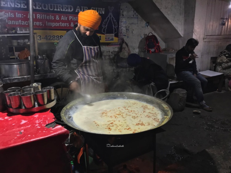 Sikh man in turban making Kheer in Amritsar India