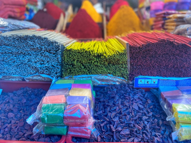 Collection of colourful incense sticks stacked in a local market