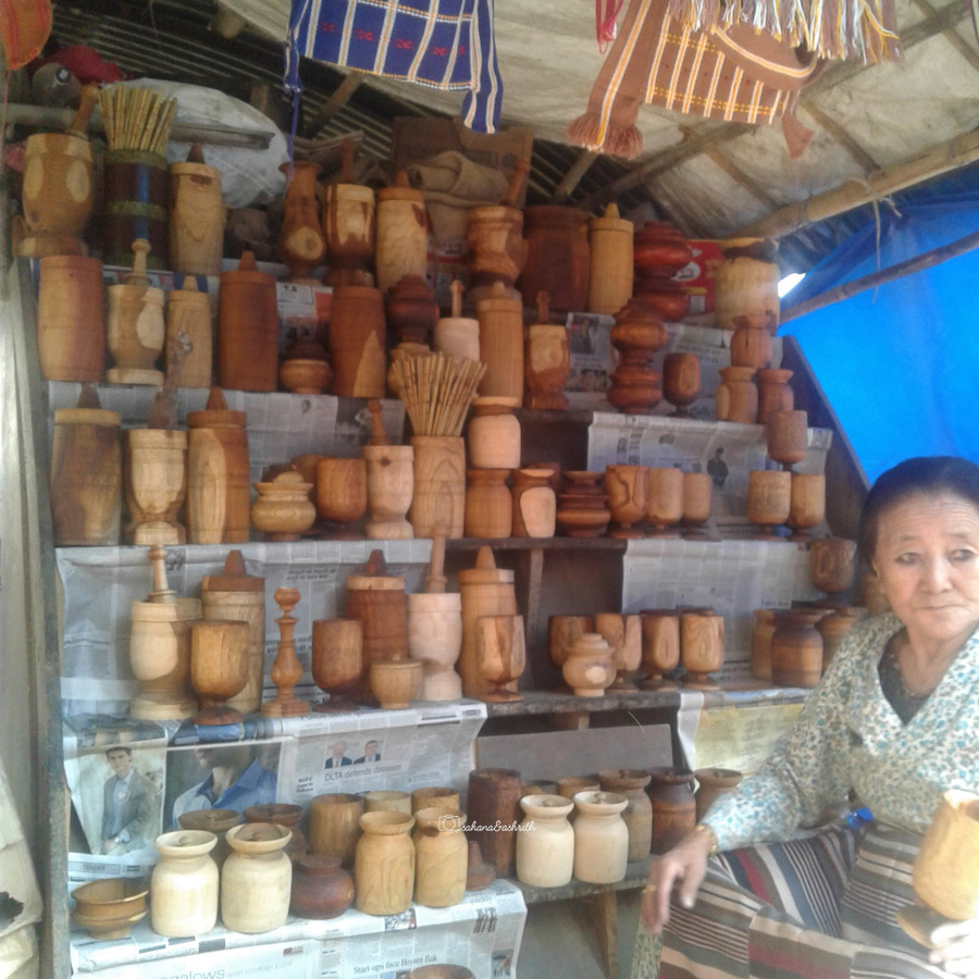Buddhist woman selling handcarved wooden cutlery at a mrket in Kaimpong