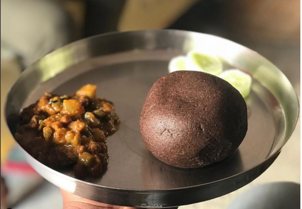 Ragi balls with leaf curries and fresh cucumbers on sides
