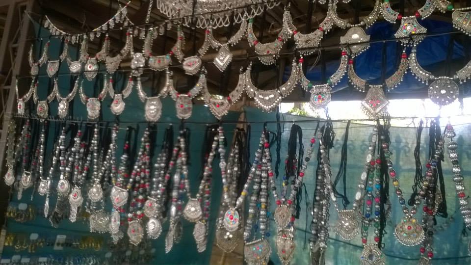Heavily detailed white metal necklaces on displat by the streetside in Ahmedabad
